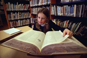 6. She’s studying at the library.